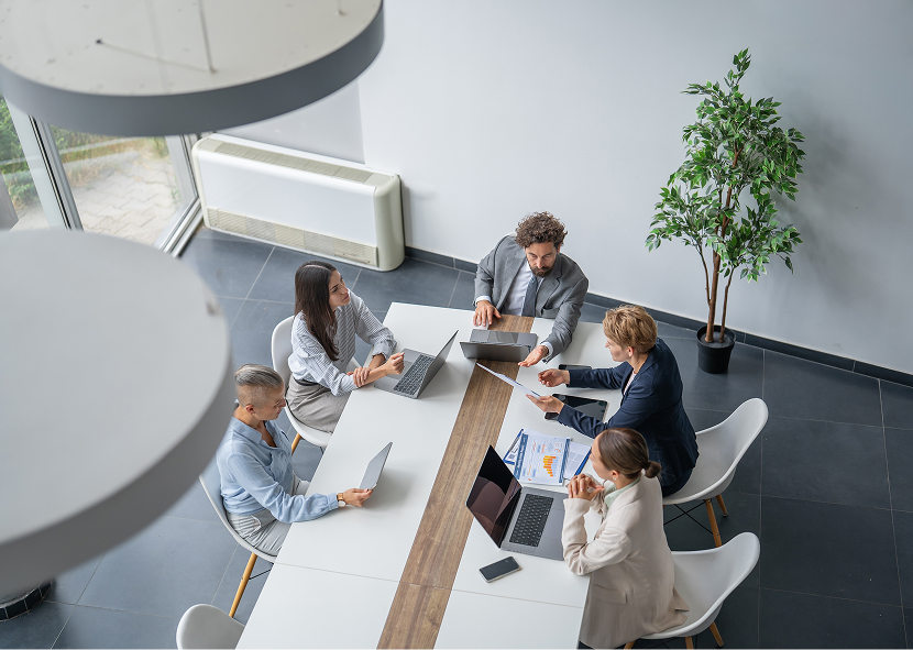 Business meeting with laptops and documents.